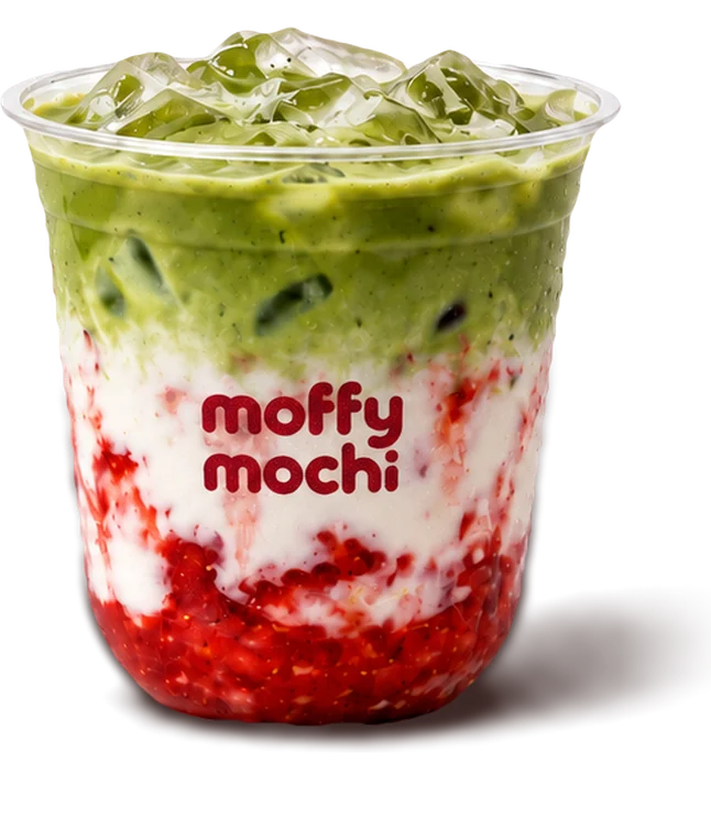 An iced strawberry matcha latte, green matcha over cold milk and a layer of strawberry
