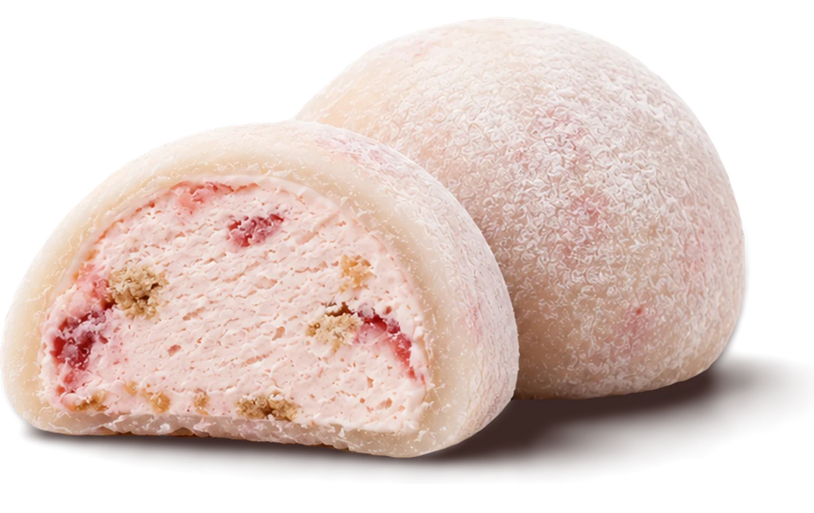 A strawberry mochi cut in half beside a whole one, showing the strawberry cheesecake cream inside