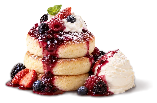 Berry soufflé pancakes topped with mixed berry compote